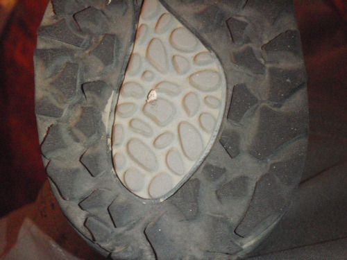 Close up of wear along heel on left shoe.